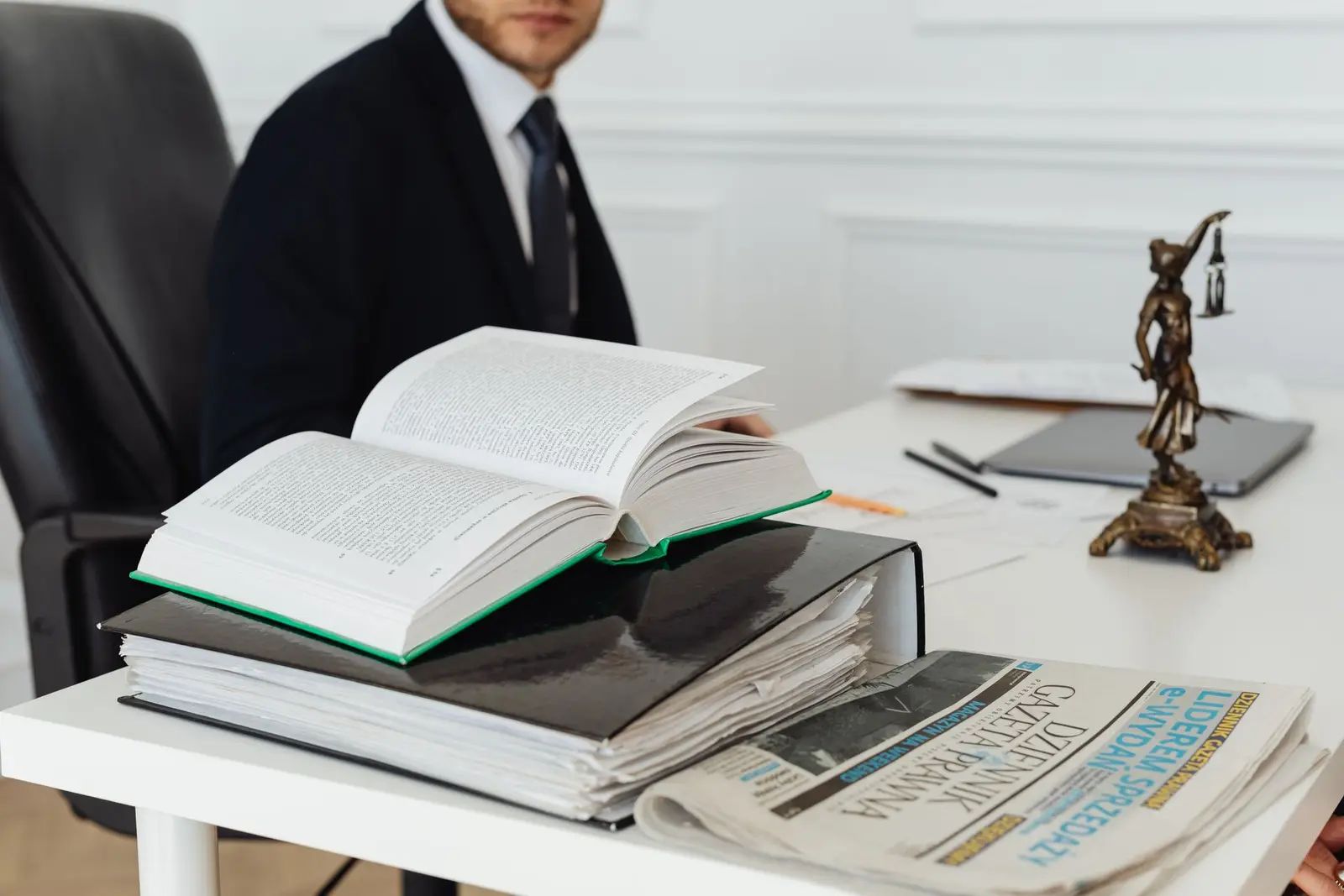 Law books and Lady Justice on a desk